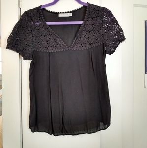 Women's black sheer detailed short sleeved v-neck top.